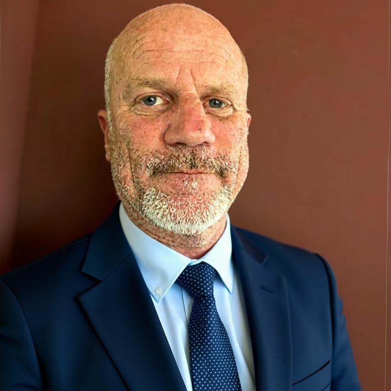 David Stanfield, CEO and Owner of StanDave LLC, in a professional blue suit